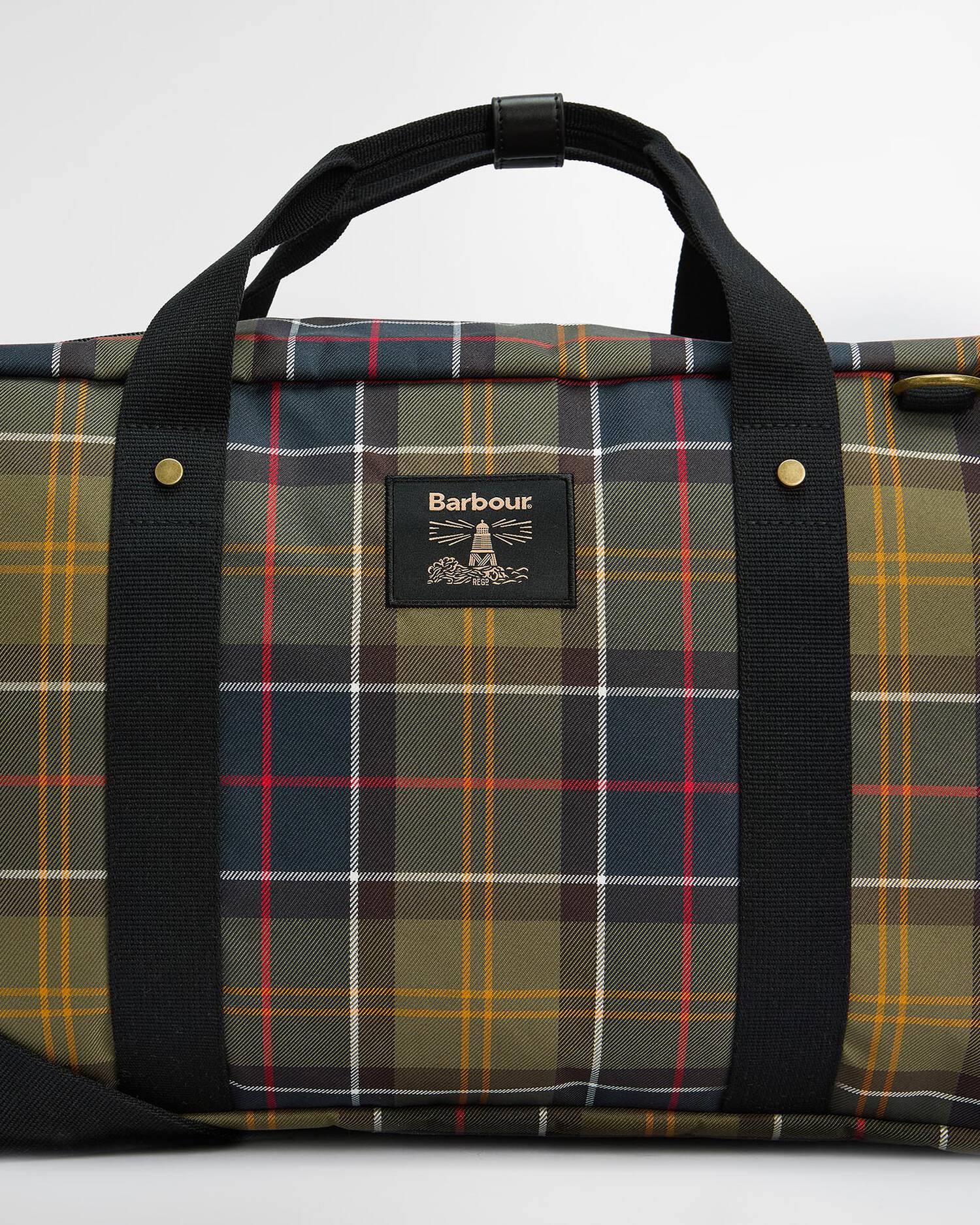 Plaid bag with black handles and visible brand logo on a white background