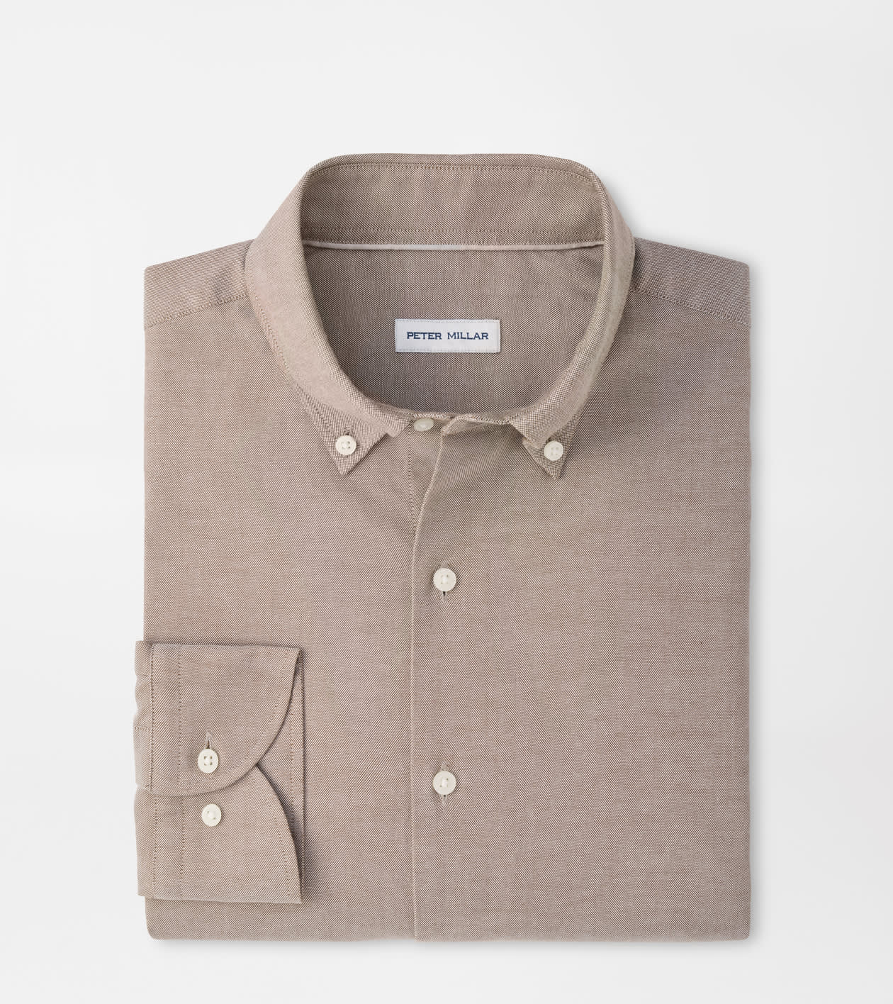 A folded Peter Millar long-sleeve button-down shirt in a light taupe-beige color, displayed on a clean white background.