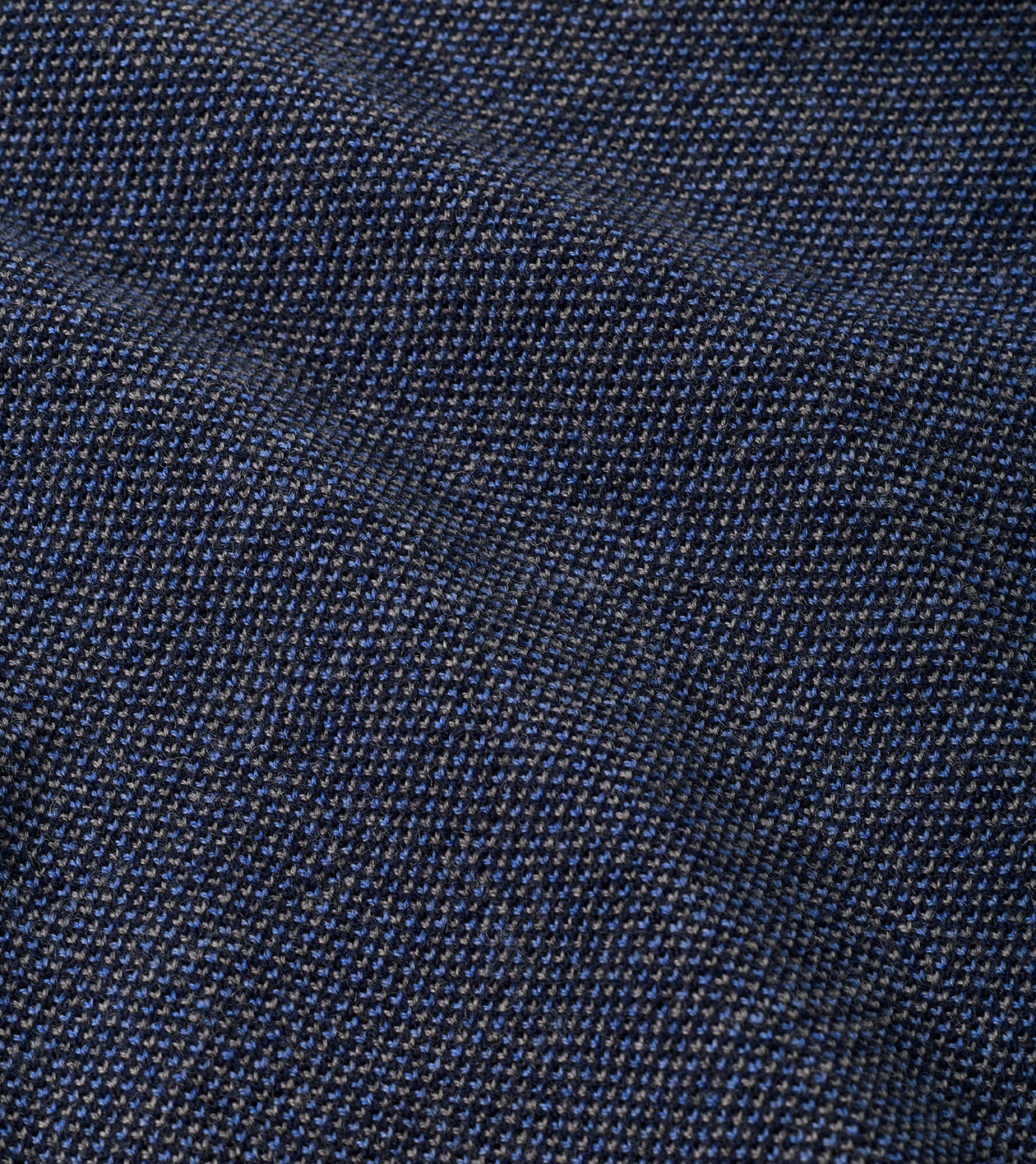 A close-up of dark navy blue woven fabric with a fine textured pattern.